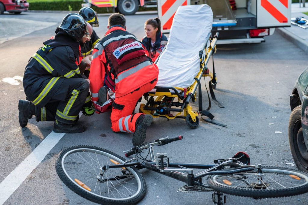paramedics attend to bike crash victim