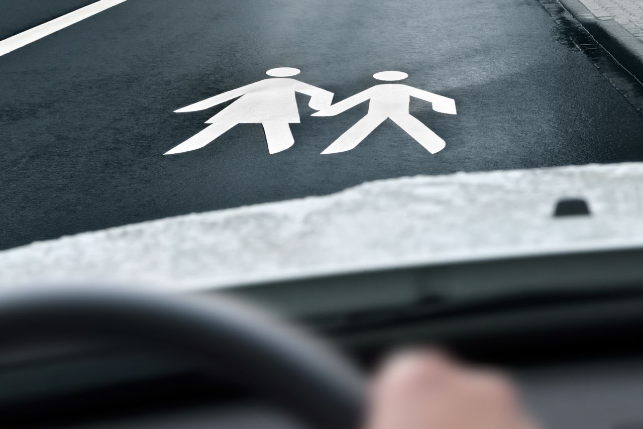 personal injury protection - figures holding hands in crosswalk